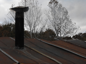 Roof with stove pipe