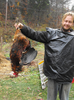 Mark holds the dead rooster