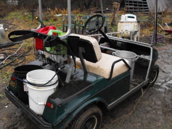 Hauling water on the golf cart in winter bud