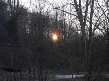 Winter sun setting behind the hill