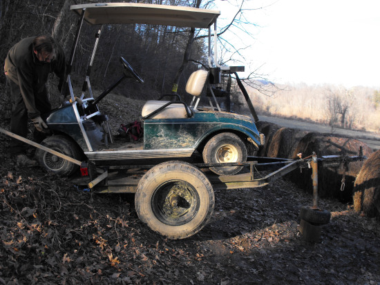 Pushing the golf cart onto the trailer