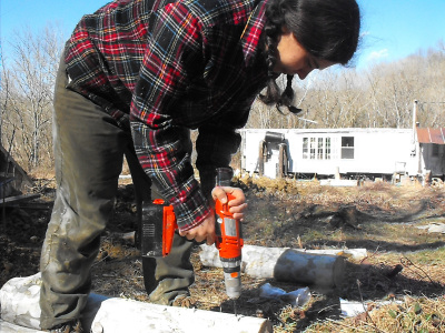 drilling holes in a shiitake log