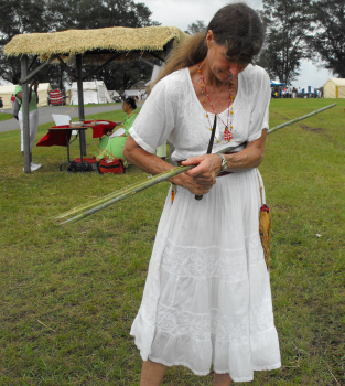 Splitting river cane to make cane for basket-making.