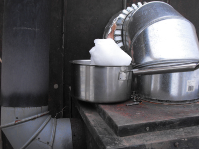 Melting snow into water on the wood stove