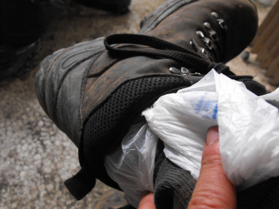 Slide a grocery bag in your boot to keep your foot dry.