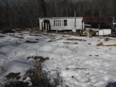 Snow retreating toward the hillside.