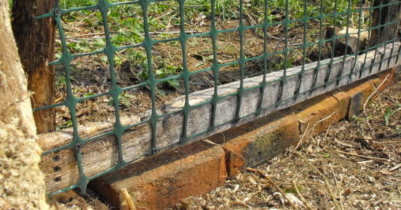 home made pasture gate brick stop