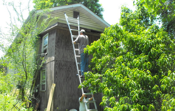 Little Giant long shot of ladder with climber and holder