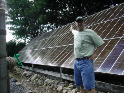 Zimmy in front of his solar panels