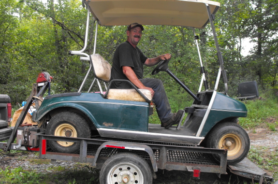 golf cart with Gary driving off trailer