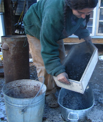 Sifting charcoal from ash