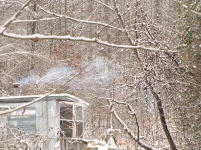 Smoke coming out of a snowy chimney