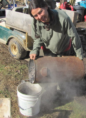 Pouring biochar into a bucket