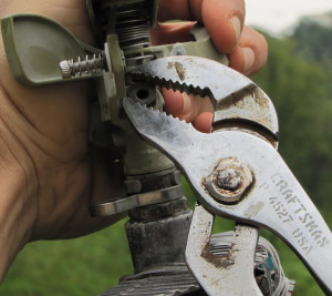 repairing a sprinkler head unit with Craftsman channel locks up close and personal