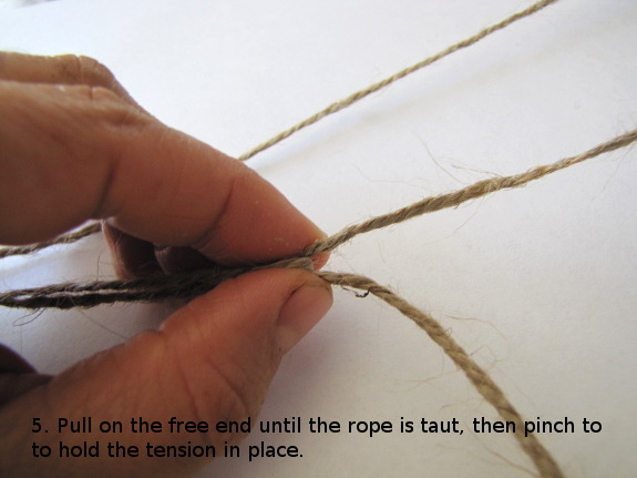 Pull on the free end until the rope is taut, then pinch to hold the tension in place.