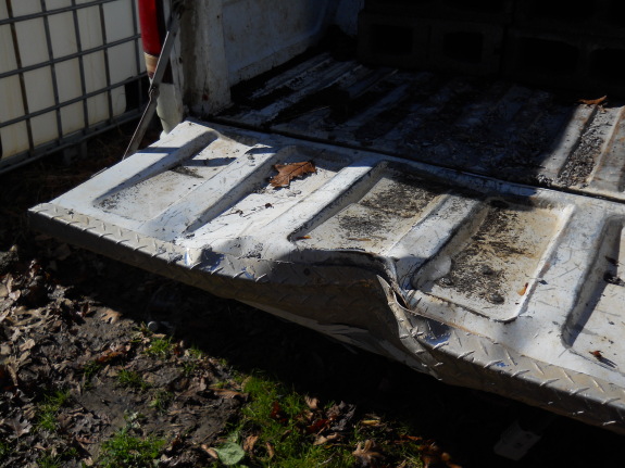 close up of truck tailgate dented and crunched