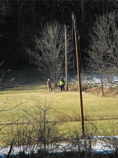Utility workers and a power line