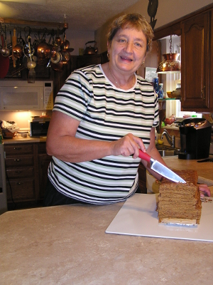 Rose Nell cutting the stack cake