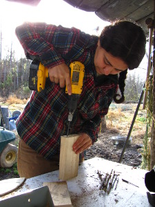 Drilling holes in a small bee nest block