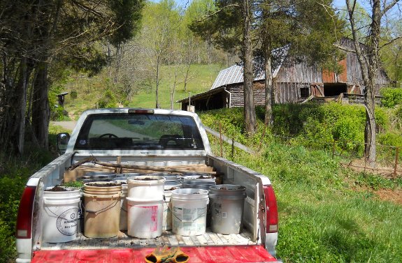 truck loaded with 5 gallon buckets and scrap cardboard