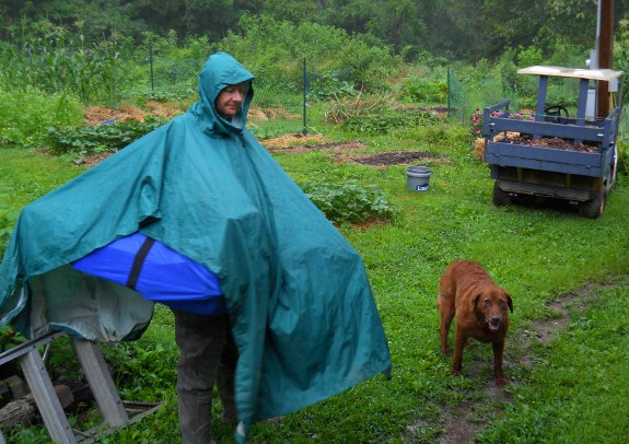 Lucy in the rain with Mark in a poncho