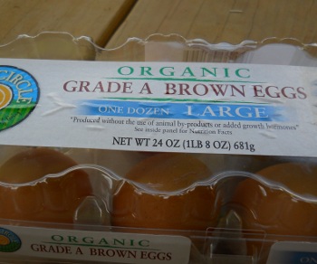 close up of carton of organic eggs brown variety