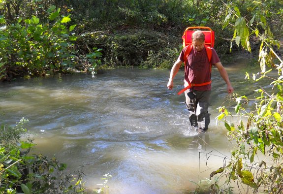 crossing a creek with modified back pack