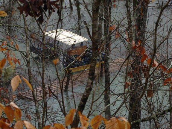 2013 flood details with image of submerged golf cart and floating foot bridge