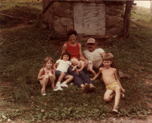 Posing in front of the outhouse