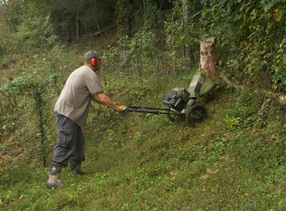Swisher trimmer mower doing an extreme uphill mowing