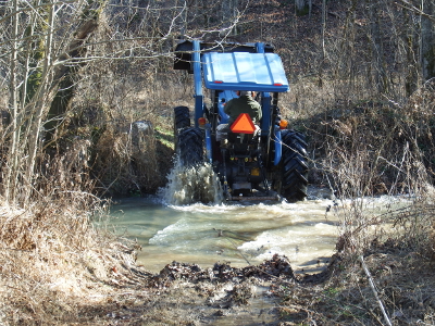 Tractor fording a creek