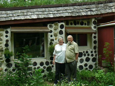 The Rylanders in front of their underground house