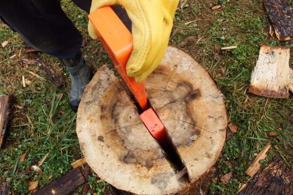 Using wedges to split firewood.