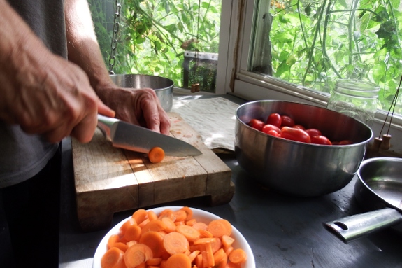 Cutting carrots on cutting board.
