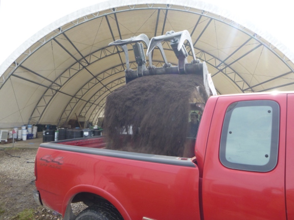 Compost being loaded into truck.
